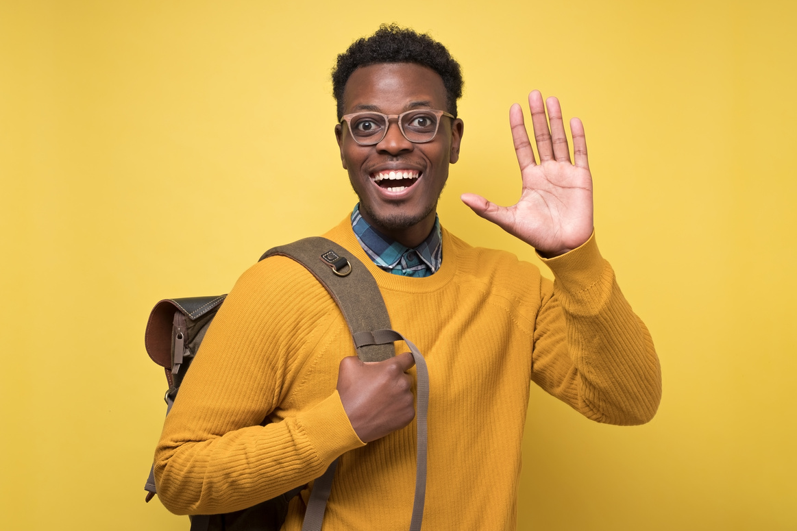 Young african american welcoming student man showing five fingers at camera